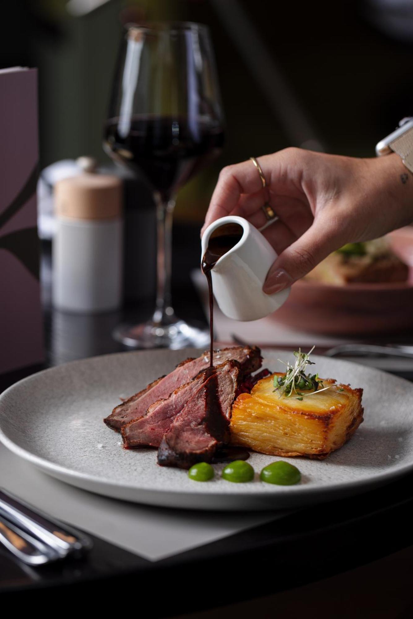 The Morrison Dublin, Curio Collection By Hilton Hotel Ngoại thất bức ảnh A steak being drizzled with a sauce